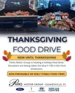 Thanksgiving Food Drive poster featuring a blue Ford F-150 truck bed full of food donations.